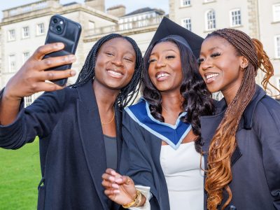 Graduate Rukayate Shobowole takes a selfie with her sisters Sekinat and Munirat. Photo: michaelorourkephotography.ie